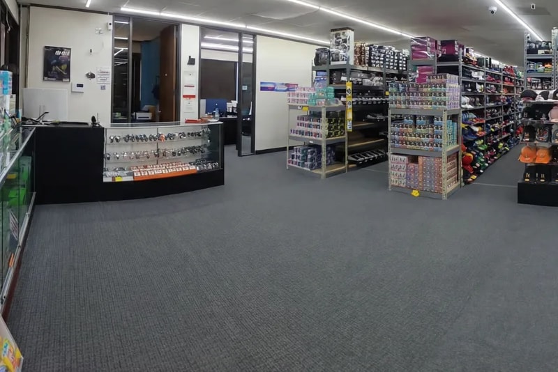 Glass-front counter case and open merchandise displays at the front of a Warner Wireless Gears showroom, product kept in clear view